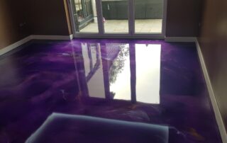 This image shows a living room with a colorful epoxy floor.